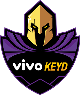 Logotipo da empresa Vivo Keyd. O logo tem a forma de um escudo, com a parte superior representando um cavaleiro medieval. O nome “Vivo Keyd” está escrito nas cores branca e amarela.